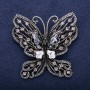 Broche papillon strass gris 55 × 57 mm métal argenté