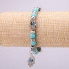 Bracelet-amulette en turquoise avec des yeux bleus sur élastique, diamètre 12 mm (±), longueur 18 cm avec inserts et pendentif
