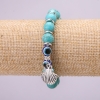 Bracelet-amulette en turquoise avec des yeux bleus sur élastique, diamètre environ 10 mm, longueur 18 cm, avec inserts et pendentif