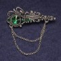Broche «Accent», strass verts et cristal, métal argenté 55×22 mm